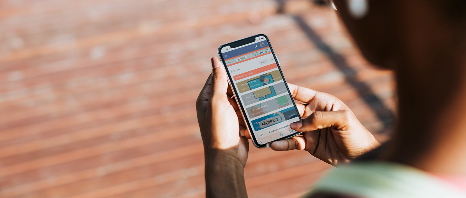 Photo of a person holding a mobile phone using My Voice