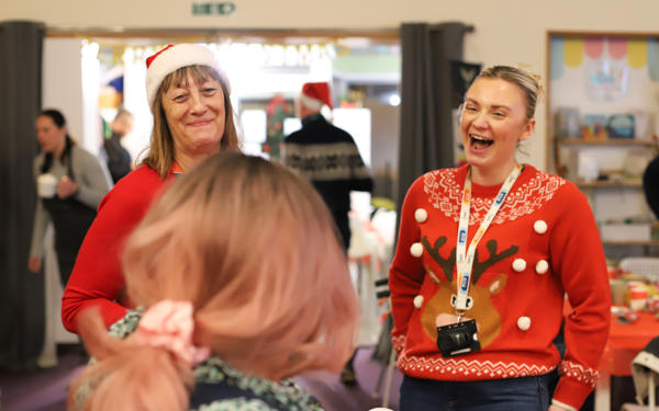 Photo of two women smiling and laughing