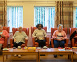 Group of customers sitting in a row of chairs