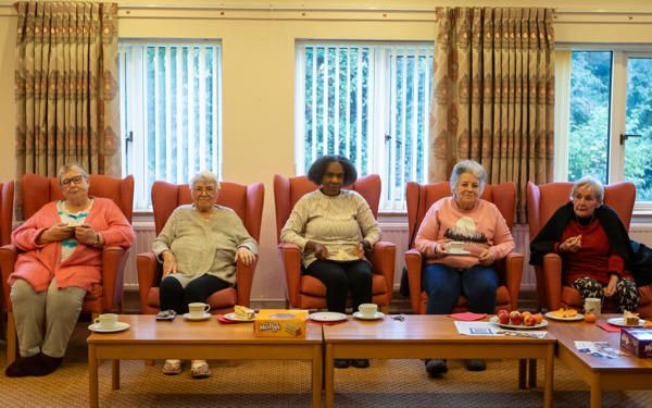 Group of customers sitting in a row of chairs