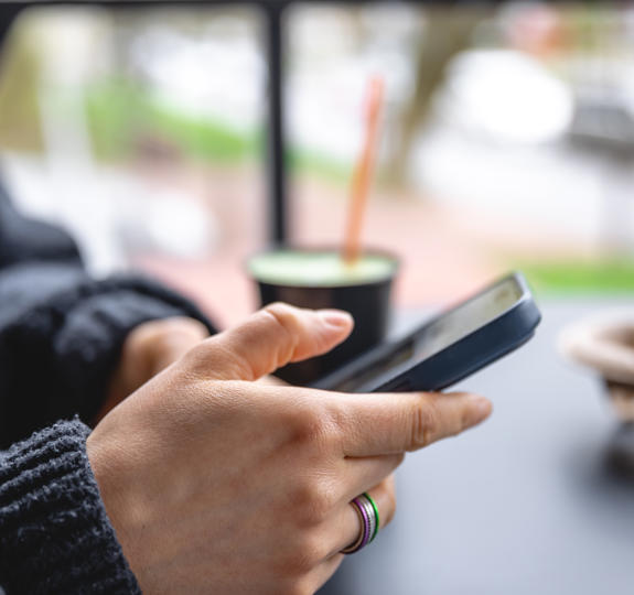 Close up photo of a woman holding a smartphone in her hands.