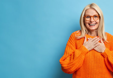 Smiling Woman With Glasses In Orange Jumper, Blue Background