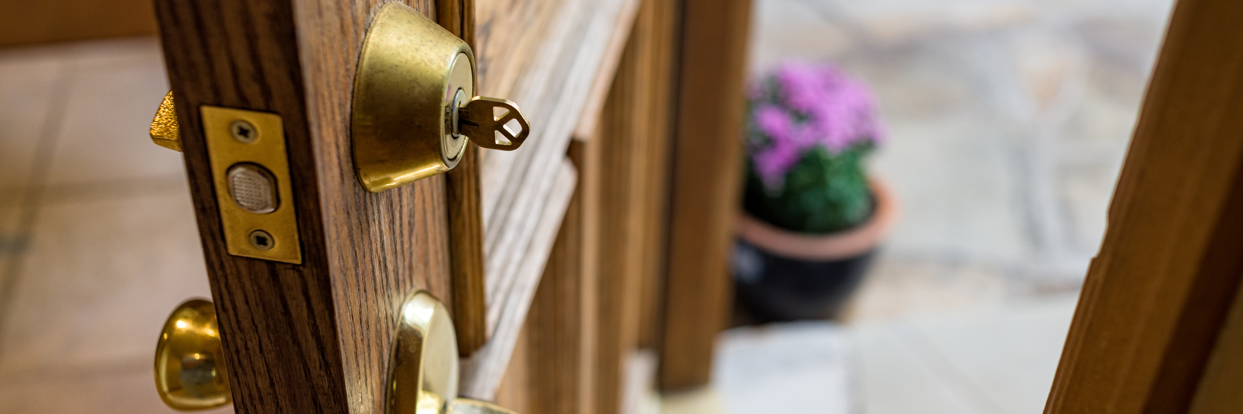 A wooden front door,slightly ajar