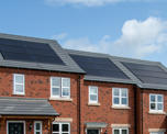 Close-up of solar panels on roofs of houses
