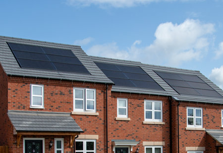 Close-up of solar panels on roofs of houses