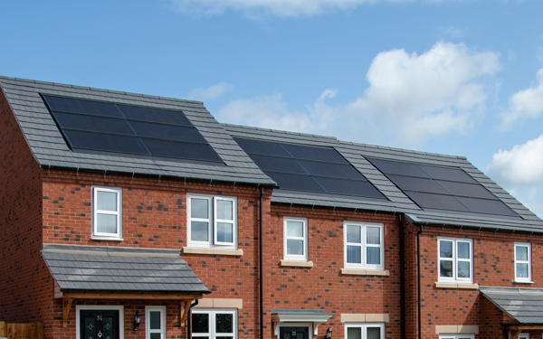 Close-up of solar panels on roofs of houses