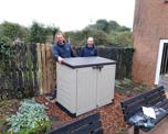 Colleagues with new storage unit outside