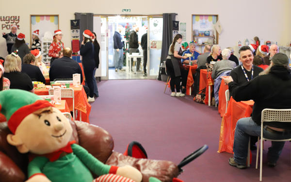 Photo of a room full of people sitting at tables